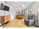 Inviting living room with hardwood floors, comfortable seating, and a mounted television at 330 N Stone St, Deland, FL 32720