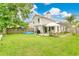 A large backyard featuring green grass, patio seating, and an inflatable swimming pool at 345 Goldstone Pl, Lake Mary, FL 32746