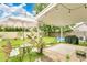 Outdoor patio features a covered area with string lights, chairs, and a barbecue grill at 345 Goldstone Pl, Lake Mary, FL 32746