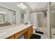 Well-lit bathroom with a vanity, sliding shower doors, and functional design at 345 Goldstone Pl, Lake Mary, FL 32746