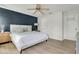 Comfortable bedroom with a queen-sized bed, stylish accent wall, and ample natural light at 345 Goldstone Pl, Lake Mary, FL 32746