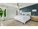 Bright bedroom features a ceiling fan, new floors, and a calming accent wall at 345 Goldstone Pl, Lake Mary, FL 32746