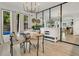 Bright dining room with modern chandelier and mirrored wall to reflect natural light at 345 Goldstone Pl, Lake Mary, FL 32746