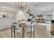 Open-concept dining room with modern light fixture connects seamlessly with living area at 345 Goldstone Pl, Lake Mary, FL 32746