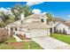 Charming two-story home featuring a two-car garage, lush landscaping, and inviting front entrance at 345 Goldstone Pl, Lake Mary, FL 32746