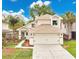 Charming two-story home featuring a two-car garage, lush landscaping, and inviting front entrance at 345 Goldstone Pl, Lake Mary, FL 32746