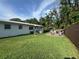Backyard featuring a wooden deck with outdoor furniture and green grass at 3702 Mirror Lake Dr, Apopka, FL 32703