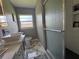 Bathroom featuring dual sinks, a shower with glass door, and marble-look tile flooring at 3702 Mirror Lake Dr, Apopka, FL 32703