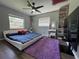 Well-lit bedroom features a modern bed frame, ceiling fan, and ample natural light from the window at 3702 Mirror Lake Dr, Apopka, FL 32703