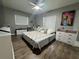 Well-lit bedroom featuring hardwood floors, ample storage, and a cozy seating area at 3702 Mirror Lake Dr, Apopka, FL 32703