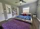Cozy bedroom featuring a plush purple rug, ceiling fan, and comfortable platform bed at 3702 Mirror Lake Dr, Apopka, FL 32703