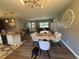 Open-concept dining room featuring a stylish table, modern lighting, and a seamless flow into the living space at 3702 Mirror Lake Dr, Apopka, FL 32703