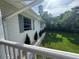 Well-maintained home exterior featuring a manicured lawn, decorative plantings, and side view of the property at 3702 Mirror Lake Dr, Apopka, FL 32703
