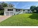 Charming two-story home with white siding, well-manicured lawn, and attached two-car garage at 3702 Mirror Lake Dr, Apopka, FL 32703