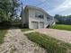 Charming two-story home with white siding, brick driveway, and attached two-car garage at 3702 Mirror Lake Dr, Apopka, FL 32703