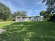 Charming two-story home with white siding, well-manicured lawn, and attached two-car garage at 3702 Mirror Lake Dr, Apopka, FL 32703