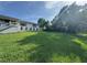 Spacious and verdant front lawn with a charming home in the background, creating a serene and inviting atmosphere at 3702 Mirror Lake Dr, Apopka, FL 32703