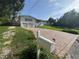 Charming two-story home with white siding, brick driveway, and well-manicured lawn at 3702 Mirror Lake Dr, Apopka, FL 32703