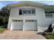 Home featuring a two-car garage and steps to front porch, set against a clear blue sky, creating curb appeal at 3702 Mirror Lake Dr, Apopka, FL 32703