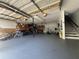 Spacious garage with ample storage, overhead lighting, and a staircase to the upper level at 3702 Mirror Lake Dr, Apopka, FL 32703