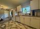 Bright kitchen with white cabinets, granite countertops, and stainless steel appliances, offering functionality and style at 3702 Mirror Lake Dr, Apopka, FL 32703