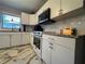 Well-lit kitchen featuring white cabinetry, modern appliances, and tiled backsplash for a clean and efficient cooking space at 3702 Mirror Lake Dr, Apopka, FL 32703