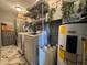 Laundry room equipped with washer, dryer, storage, and water heater at 3702 Mirror Lake Dr, Apopka, FL 32703