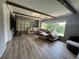 Inviting living room featuring wood beam ceiling, large windows, and comfortable seating, perfect for relaxation at 3702 Mirror Lake Dr, Apopka, FL 32703