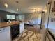 Spacious living area with an open floor plan connecting the kitchen, dining, and living room areas at 3702 Mirror Lake Dr, Apopka, FL 32703