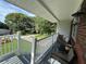 Comfortable front porch with seating, a view of the street and surrounding greenery at 3702 Mirror Lake Dr, Apopka, FL 32703