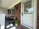 Inviting front porch with chairs, plants, and a decorative wreath on the front door at 3702 Mirror Lake Dr, Apopka, FL 32703