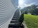 Home exterior stairs leading up to the porch with a small decorative tree at 3702 Mirror Lake Dr, Apopka, FL 32703