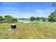 Enjoy picturesque lake views from this large, fenced backyard, perfect for relaxing or entertaining at 3824 Johnson St, Orlando, FL 32805