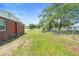 Expansive fenced backyard with a peaceful lake view, perfect for Gathering activities and entertaining at 3824 Johnson St, Orlando, FL 32805