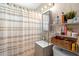 Neutral bathroom showcasing a shower with a striped curtain, vanity and shelving at 3824 Johnson St, Orlando, FL 32805