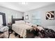 Cozy bedroom featuring a comfortable bed, natural lighting, and laminate floors at 3824 Johnson St, Orlando, FL 32805