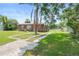 Charming single-story home boasting a well-manicured lawn, mature trees, and paved driveway at 3824 Johnson St, Orlando, FL 32805