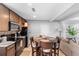 Eat-in kitchen featuring wood cabinets, black appliances and easy access to the adjacent living area at 3824 Johnson St, Orlando, FL 32805