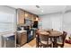 Eat-in kitchen with wood cabinets, black appliances, and a cozy dining table for casual meals at 3824 Johnson St, Orlando, FL 32805
