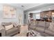 Inviting living room flowing into kitchen, featuring neutral tones and comfortable seating at 3824 Johnson St, Orlando, FL 32805
