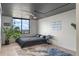 Bright bedroom with a large window, minimalist decor, and herringbone floors for a serene and stylish retreat at 400 E Colonial Dr # 1103, Orlando, FL 32803