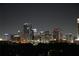 Nighttime view of a vibrant city skyline with brightly lit buildings creating an enchanting urban ambiance at 400 E Colonial Dr # 1103, Orlando, FL 32803