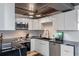 Modern kitchen featuring sleek white cabinets, black marble countertops, and stainless steel appliances for a luxurious cooking experience at 400 E Colonial Dr # 1103, Orlando, FL 32803