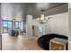 Modern living room featuring herringbone floors, a stylish chandelier, and a comfortable seating area with natural light at 400 E Colonial Dr # 1103, Orlando, FL 32803