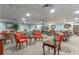 Community lounge area furnished with tables, chairs, sofas, and a library at 400 E Colonial Dr # 1103, Orlando, FL 32803