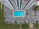 Aerial shot of a modern pool surrounded by a parking area, greenery, and walkways, blending urban living with leisure at 400 E Colonial Dr # 1103, Orlando, FL 32803