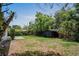 Large backyard featuring mature trees and a storage shed at 418 Tulane Dr, Altamonte Springs, FL 32714