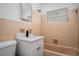 Bathroom featuring tile walls, updated vanity with a new countertop, and a bright window at 418 Tulane Dr, Altamonte Springs, FL 32714
