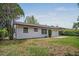 Exterior showcasing lush backyard and the back of the home with concrete patio at 418 Tulane Dr, Altamonte Springs, FL 32714