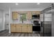 Modern kitchen featuring stainless steel appliances and light wood cabinets at 418 Tulane Dr, Altamonte Springs, FL 32714